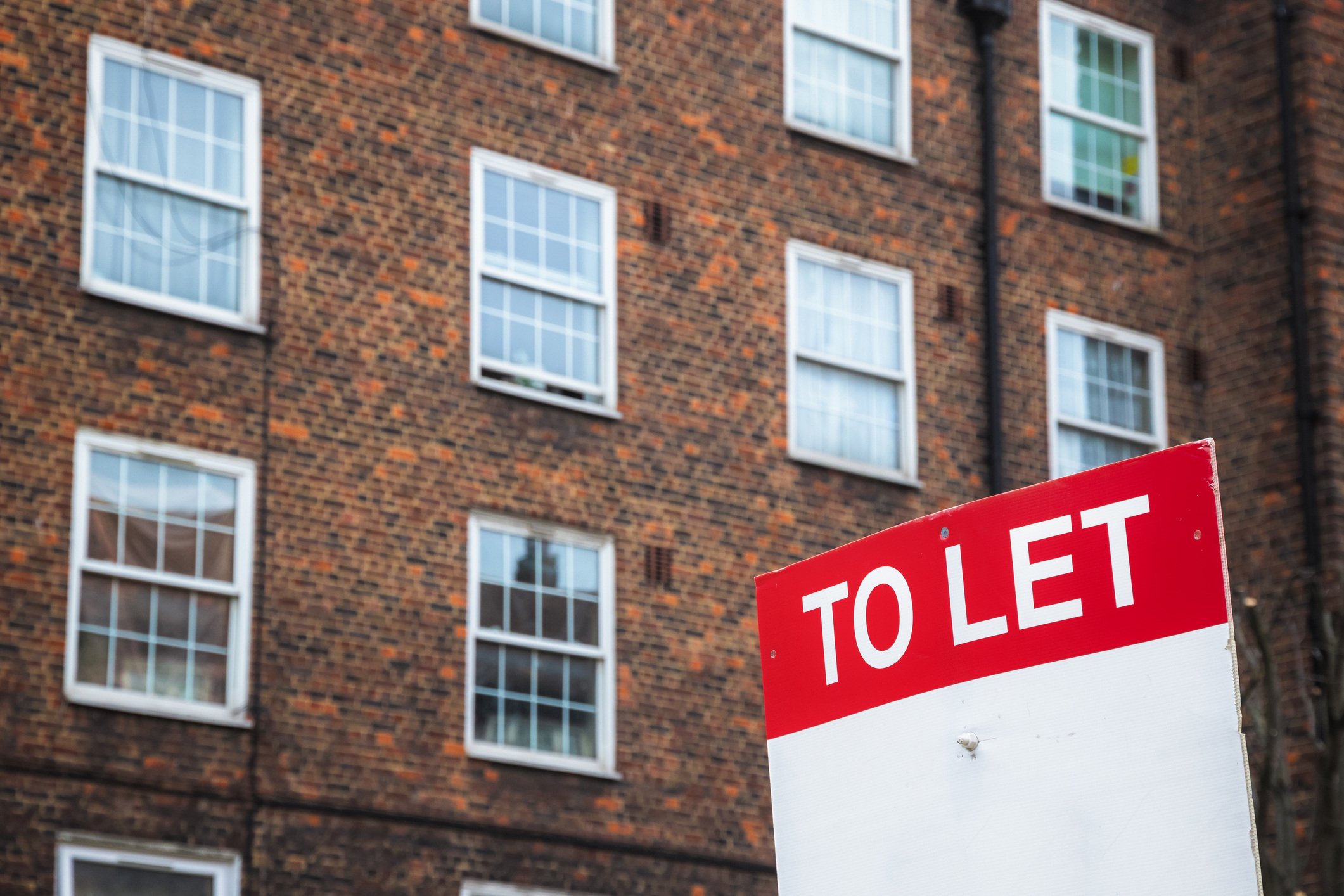 South London - To Let sign with council housing flats at Rockingham estate in the background around Elephant and Castle area