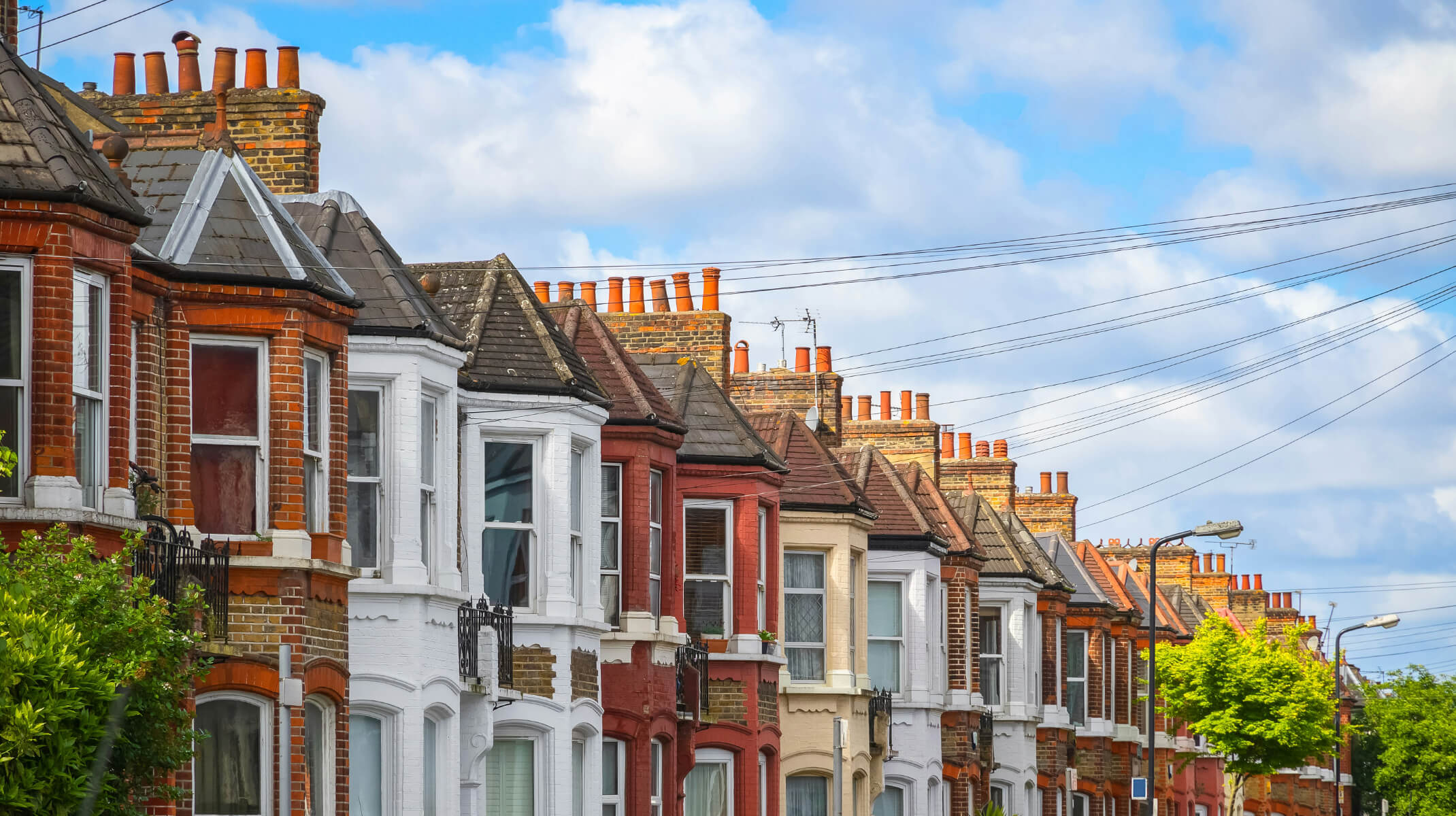 Row of orange, brown, white and red brick houses in UK.