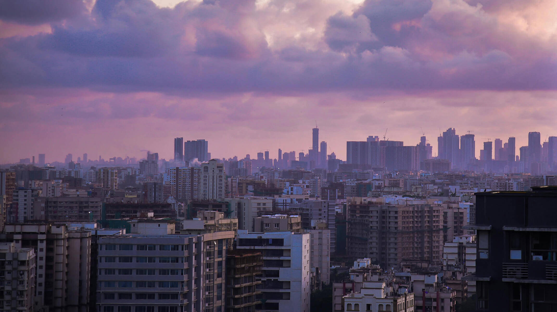 rooftop view of Indian city under violet cloudy sky